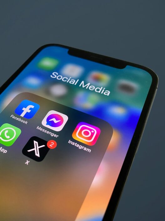 a close up of a cell phone with social media icons